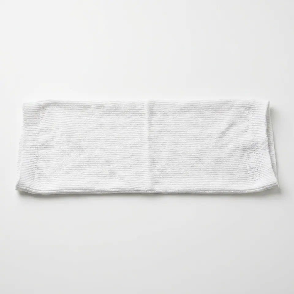 Flat-lying piece of white tubular knitted fabric
